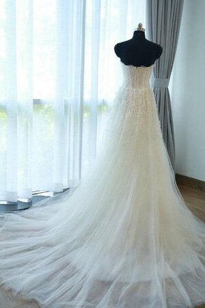 Robe de mariée manche nulle en tulle avec fleurs longueru au niveau de sol fermeutre eclair