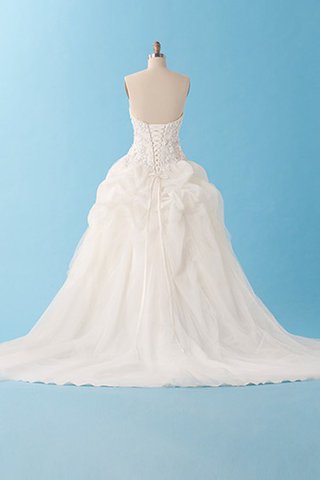 Robe de mariée elegante longue en dentelle dans l'eglise de lotus